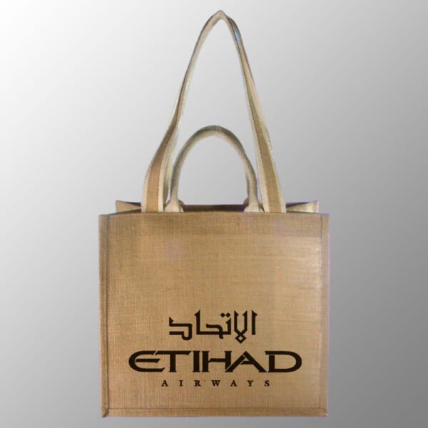 Jute Bag With Double Handles. Customized with one-color screen print in your required artwork for free with up to 25% ink coverage. Model # 2067 is made from Natural 14x 15 way of Jute with PP Matt Lamination Inside.